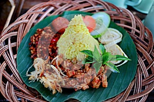 Nasi Kuning. Javanese turmeric rice with assorted side dishes photo