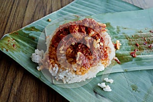 Nasi lemak or fragrant rice cooked and peppered with anchovies, cucumber and omelette . Popular in South East Asia