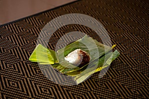 Nasi lemak is a Malay fragrant rice dish cooked in coconut milk and pandan or banana leaf