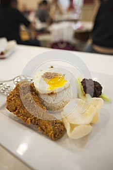 Nasi Lemak, a Malay fragrant rice dish cooked in coconut milk, served with side dishes