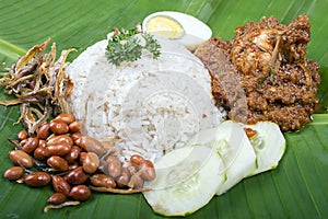 Nasi lemak, a traditional malay curry paste rice dish served on a banana leaf