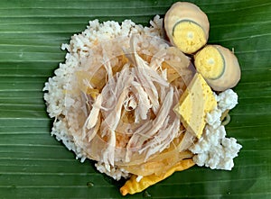 Nasi Liwet Solo, a traditional food from Surakarta, Indonesia, savory steamed rice with pulled chicken curry and chicked egg