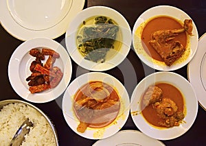 Nasi Padang Dishes served on plates ready to be eaten photo