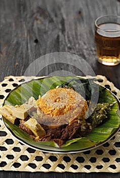 Nasi Padang Served with Rendang, Young Jackfruit Curry,  Cassava Leaves, and Sambal Hijau or Lado Mudo photo