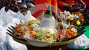 Nasi tumpeng (cone rice) served with urap-urap (Indonesian salad), fried chicken and noodles