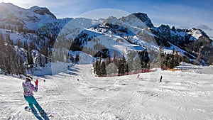 Nassfeld - A snowboarding girl going down the slope