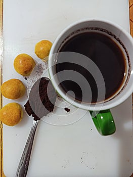 Naster cake, coffee powder, spoon, cup of coffee