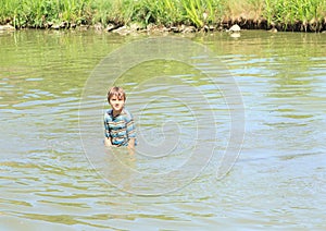 Nasty boy standing in water