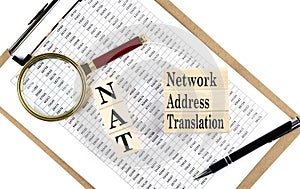 NAT Network Address Translation text on wooden block on chart background