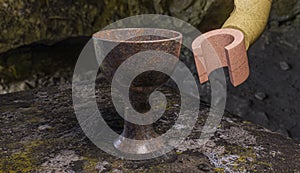 3D art - Lego Indiana Jones, Holy Grail on stone table with cobwebs and rust photo