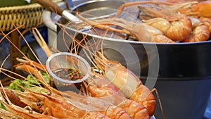 National Asian Exotic ready to eat seafood at night street market food court in Thailand. Delicious Grilled Prawns or