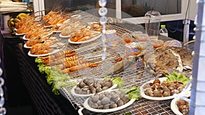 National Asian Exotic ready to eat seafood at night street market food court in Thailand. Delicious Grilled Prawns or