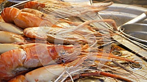 National Asian Exotic ready to eat seafood at night street market food court in Thailand. Delicious Grilled Prawns or Shrimps and