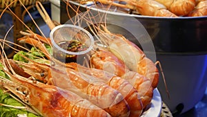 National Asian Exotic ready to eat seafood at night street market food court in Thailand. Delicious Grilled Prawns or Shrimps and