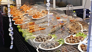 National Asian Exotic ready to eat seafood at night street market food court in Thailand. Delicious Grilled Prawns or Shrimps and