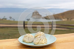 National Buryat Food on the Table on Blur Lake Baikal Background