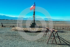 National Chilean flag flying with blue sky background in Atacama Desert, Chile