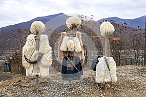 National clothes of Georgian shepherds burka and papakha against mountains