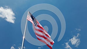 National country flag on blue sky background. Flying fabric symbol