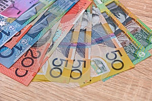 National currency. Colorful australian dollar banknotes on wooden table close up