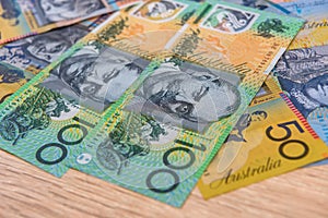 National currency. Colorful australian dollar banknotes on wooden table close up