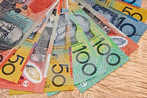 National currency. Colorful australian dollar banknotes on wooden table close up