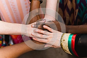 National diversity. People of different appearance and nationality stand in a circle together and hold hands. Team building and pa