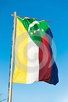 National flag of Comoros on flagpole