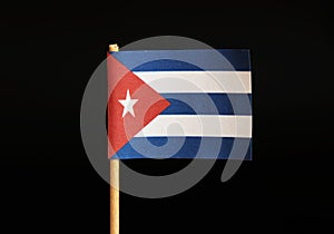 A national flag of Cuba on toothpick and on black background. Cuba is famous for criminality and import and export drugs and cigar