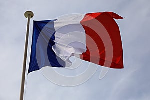 The national flag of France against cloudy sky