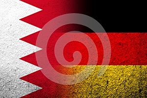 The national flag of Germany with The Kingdom of Bahrain national flag. Grunge background