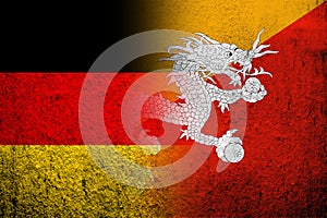 The national flag of Germany with Kingdom of Bhutan National flag. Grunge background