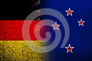 The national flag of Germany with National flag of New Zealand. Grunge background