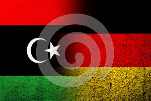 The national flag of Germany with The State of Libya National flag. Grunge background