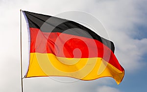 National flag of Germany waving on flagpole against sky photo