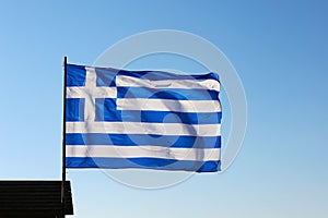 The national flag of Greece against the sky. Greece Independence Day. Waving Greek twocolor. Popularly referred to as