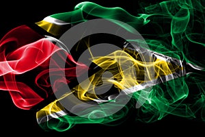 National flag of Guyana made from colored smoke isolated on black background. Abstract silky wave background.