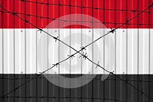 National flag of Iraq on fence.