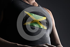 The national flag of Jamaica on the athlete& x27;s chest photo