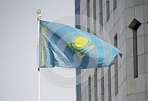 National flag of Kazakhstan waving from wind in Almaty photo