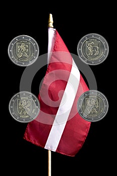 National flag of Latvia and commemorative 2 euro coins