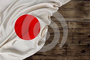 National flag of modern state of Japan, beautiful silk, background old wood, concept of tourism, economy, politics, emigration,