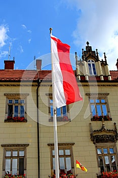 The national flag of Poland on a mast in a vertical arrangement