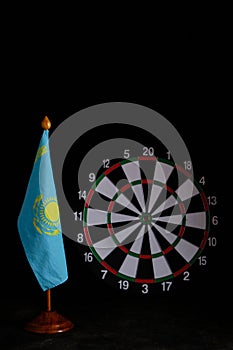 National flag Republic Kazakhstan on background dartboard.Concept of a country and republic under gun