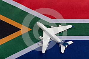 National flag of Republic of South Africa and toy airplane close up. Resumption of flights after quarantine