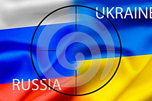 The national flag of Russia and Ukraine against the background of the sight, military conflict