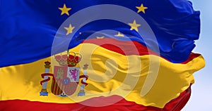 National flag of Spain waving with the European Union flag in the background on a clear day