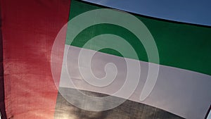 National Flag Of UAE Waving In The Wind sunset. Flag of United Arab Emirates on Sun Background. Sign of Dubai. National