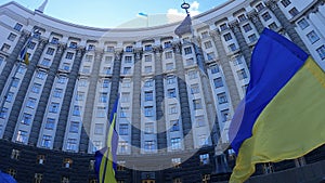 National flag of Ukraine against the background of the government building in Kyiv