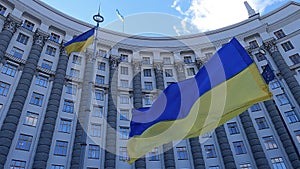 National flag of Ukraine against the background of the government building in Kyiv